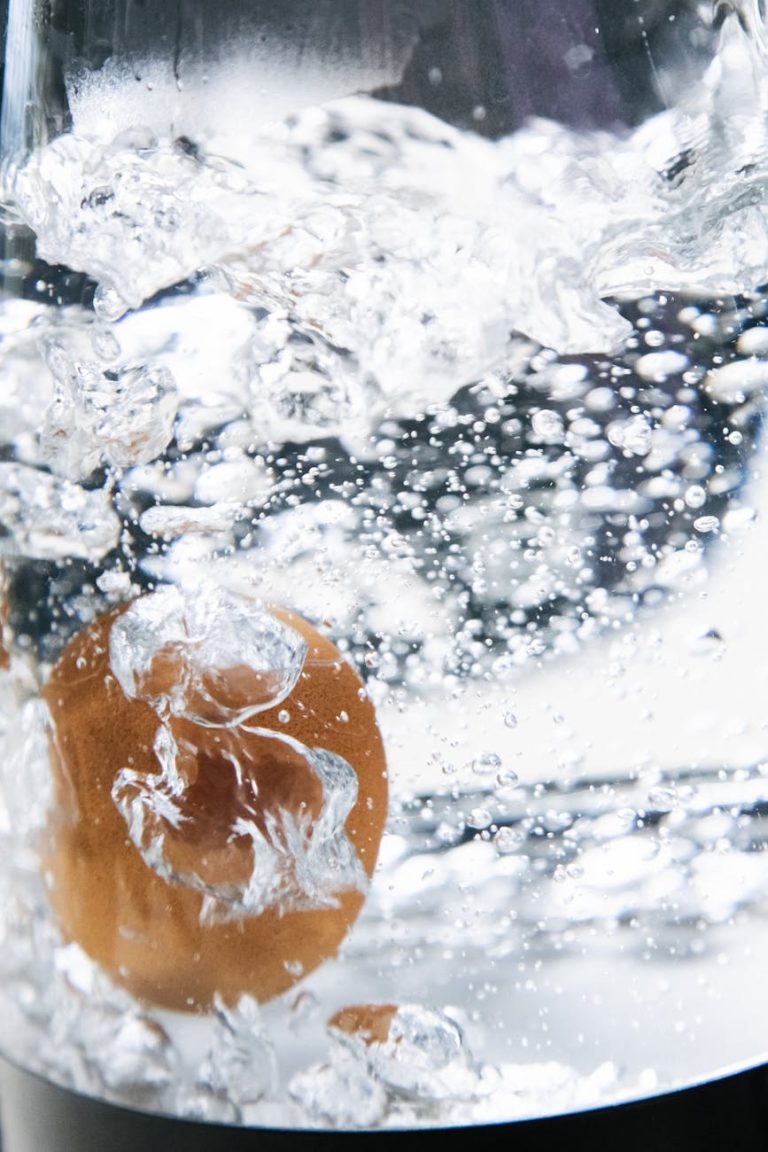 A detailed shot capturing an egg boiling in a pot, surrounded by bubbles and hot water.