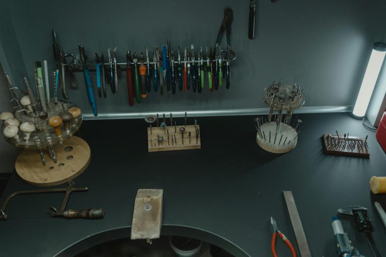 A well-organized jeweler's workstation with various tools, pliers, and accessories displayed neatly.