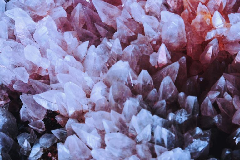 A stunning close-up of naturally occurring pink quartz crystals with sharp details.